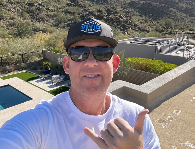 Clay tile roofs with mountain backdrop and palms